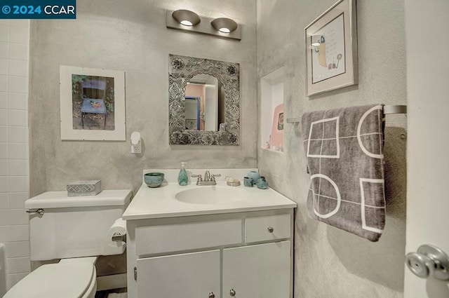 bathroom featuring vanity and toilet