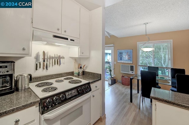 kitchen with a textured ceiling, white electric range oven, white cabinetry, and hanging light fixtures