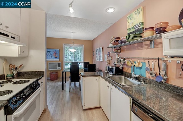 kitchen with white appliances, a textured ceiling, sink, pendant lighting, and white cabinets