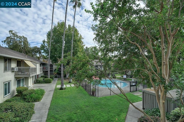 view of pool featuring a lawn