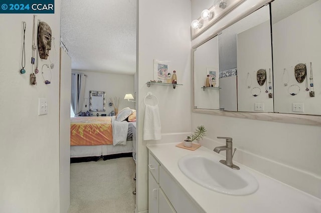 bathroom with vanity and a textured ceiling