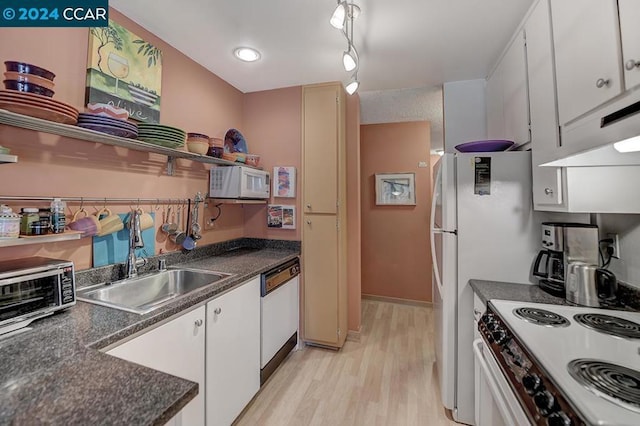 kitchen featuring rail lighting, white appliances, white cabinetry, and sink