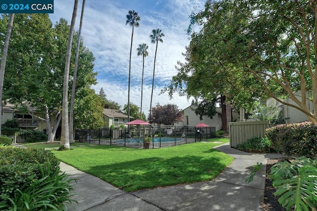 view of community featuring a lawn and a pool