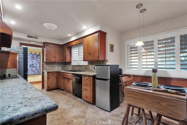 kitchen featuring decorative light fixtures, backsplash, black appliances, and sink