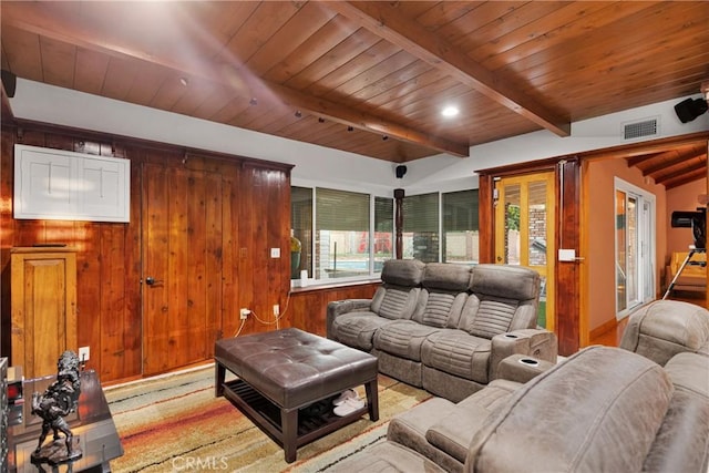 living room with beam ceiling, wood walls, and wood ceiling