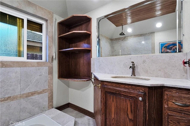 bathroom with wooden ceiling, decorative backsplash, and vanity