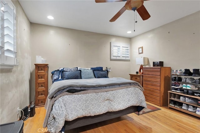 bedroom with ceiling fan and hardwood / wood-style floors