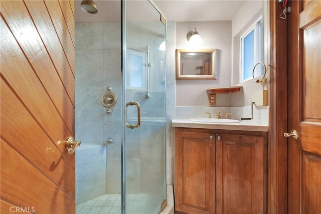 bathroom featuring an enclosed shower and vanity