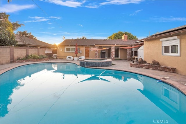 view of swimming pool with a patio area and an in ground hot tub