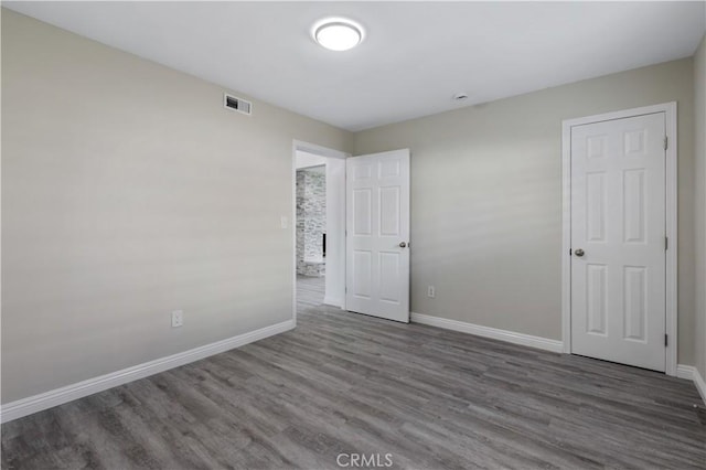 spare room featuring wood-type flooring