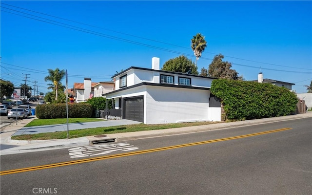 view of front of property with a garage and a front lawn