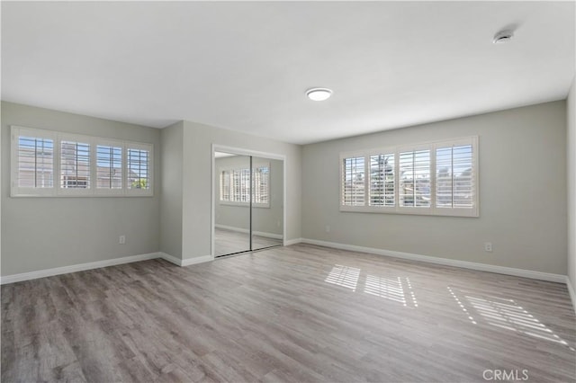 unfurnished bedroom featuring a closet and light hardwood / wood-style floors