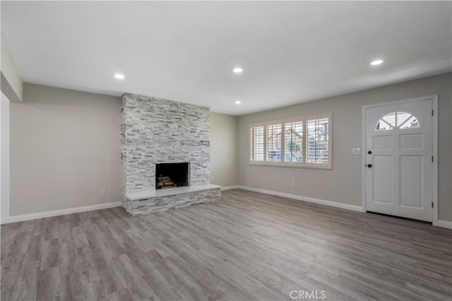 unfurnished living room featuring hardwood / wood-style floors and a fireplace