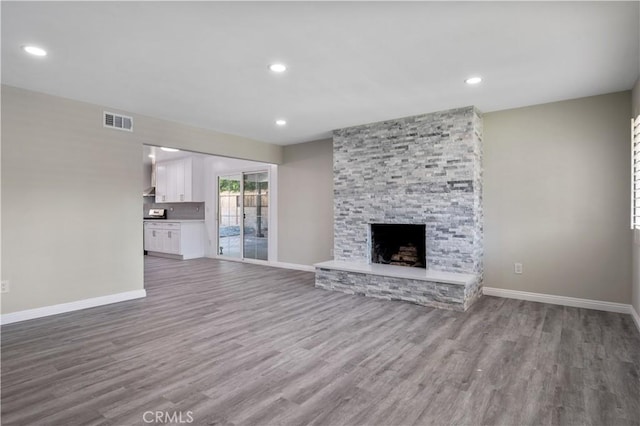 unfurnished living room featuring a fireplace and hardwood / wood-style flooring