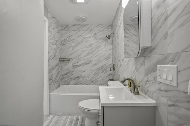 full bathroom featuring vanity, bathtub / shower combination, and toilet