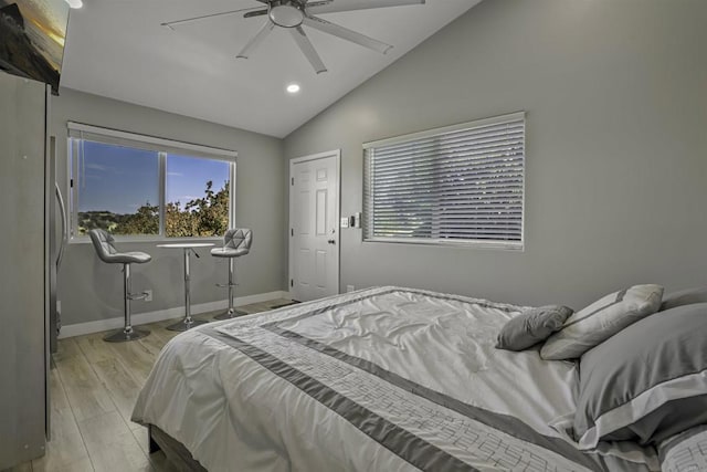 bedroom featuring lofted ceiling, light hardwood / wood-style floors, and ceiling fan