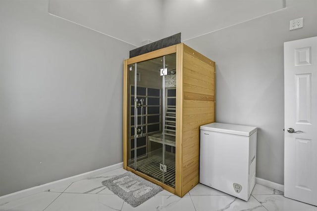 bathroom with marble finish floor and baseboards