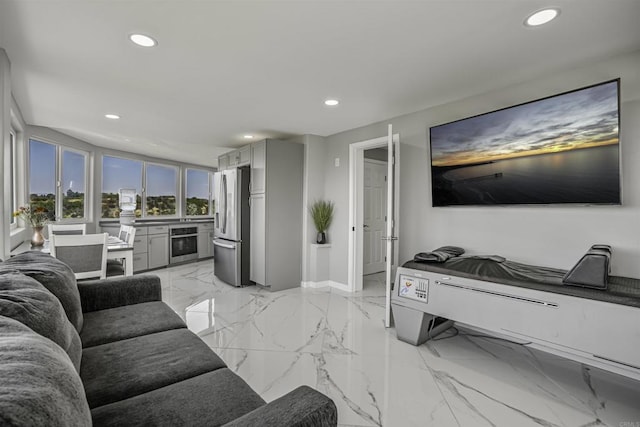 living room featuring recessed lighting, marble finish floor, and baseboards