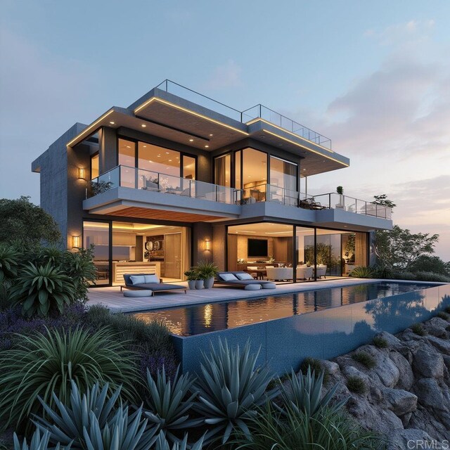 rear view of house with an outdoor hangout area, a balcony, an infinity pool, and a patio area