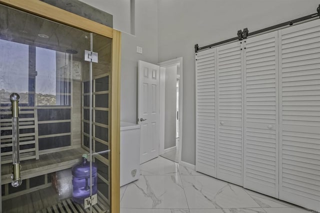 bathroom with baseboards and marble finish floor