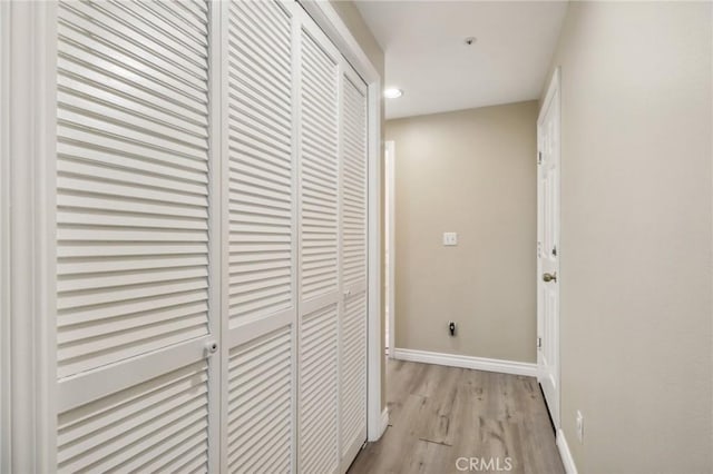 corridor with light hardwood / wood-style flooring