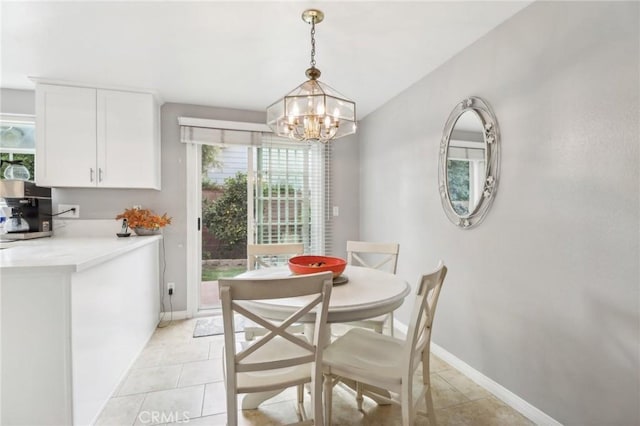 tiled dining space featuring a notable chandelier and a healthy amount of sunlight