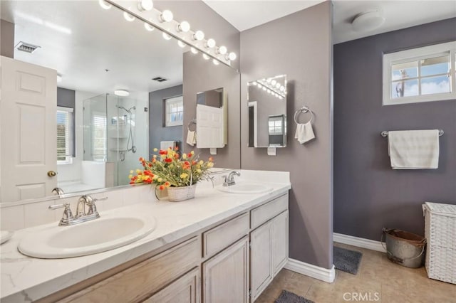 bathroom featuring tile patterned floors, plenty of natural light, vanity, and an enclosed shower