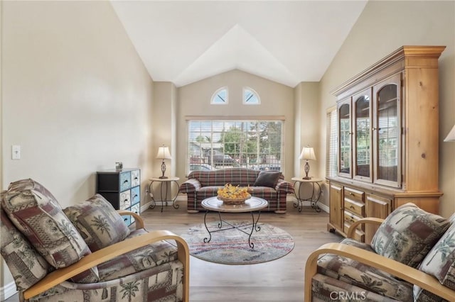 living room with vaulted ceiling and light hardwood / wood-style flooring