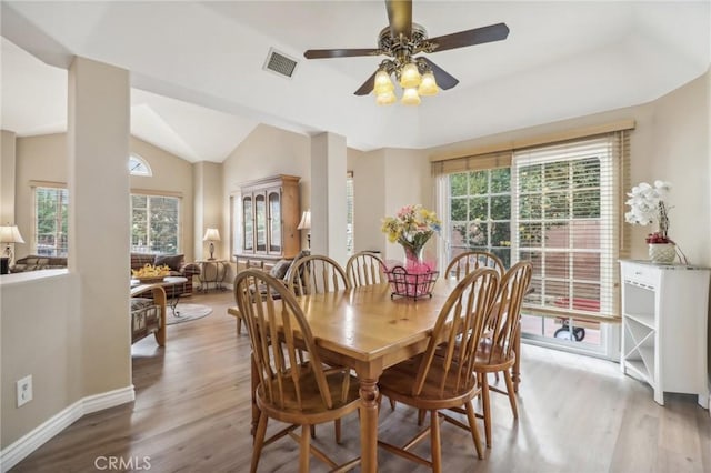 dining area featuring light hardwood / wood-style floors, vaulted ceiling, and ceiling fan