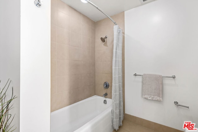 bathroom with tile patterned floors and shower / bathtub combination with curtain