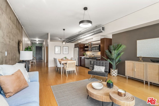 living room featuring hardwood / wood-style floors and ceiling fan