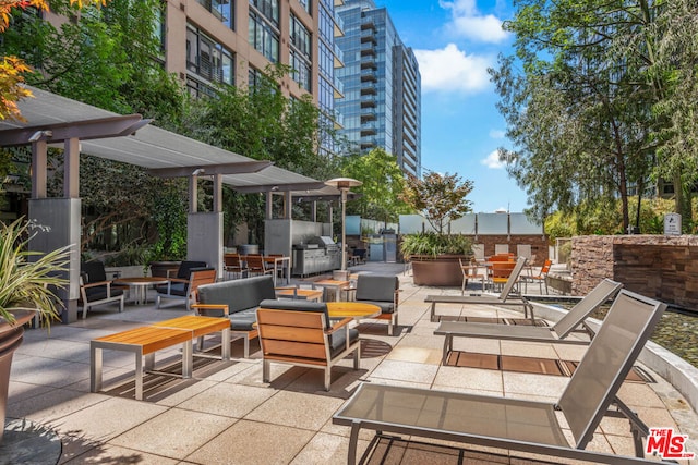 view of patio / terrace featuring a pergola, grilling area, and an outdoor living space