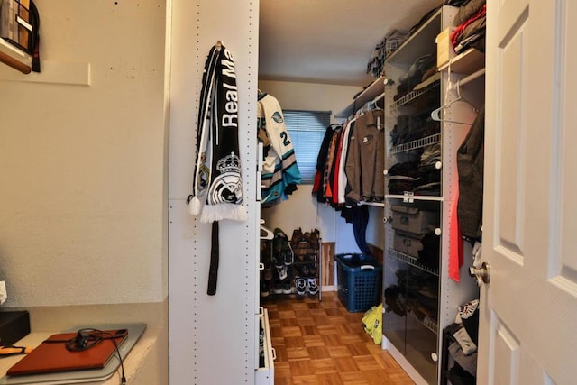 spacious closet with parquet flooring