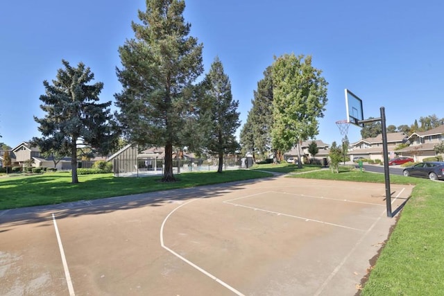 view of sport court featuring a lawn