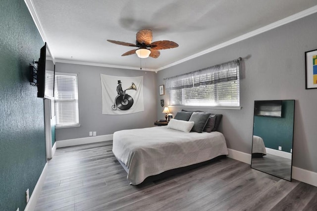 bedroom featuring crown molding, ceiling fan, and wood-type flooring