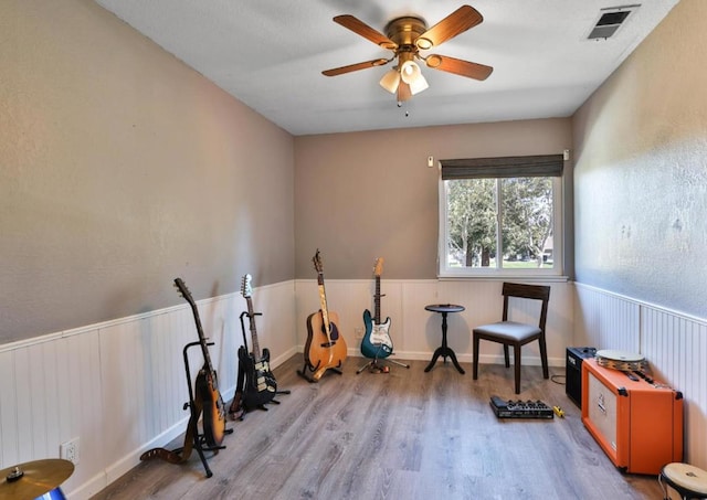 workout area featuring ceiling fan and wood-type flooring