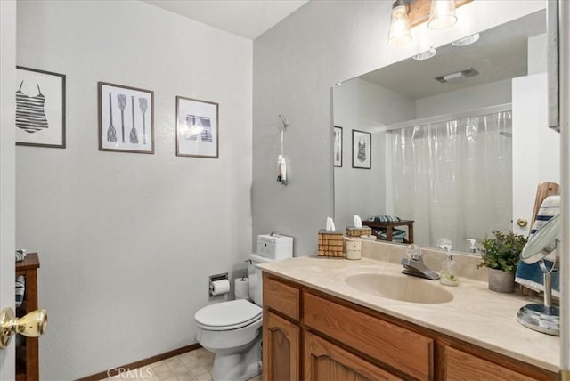 bathroom featuring vanity, toilet, and curtained shower