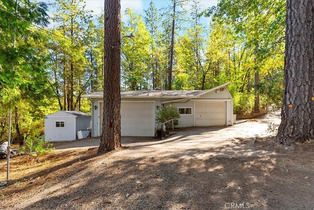 view of front of home featuring a storage unit and a garage