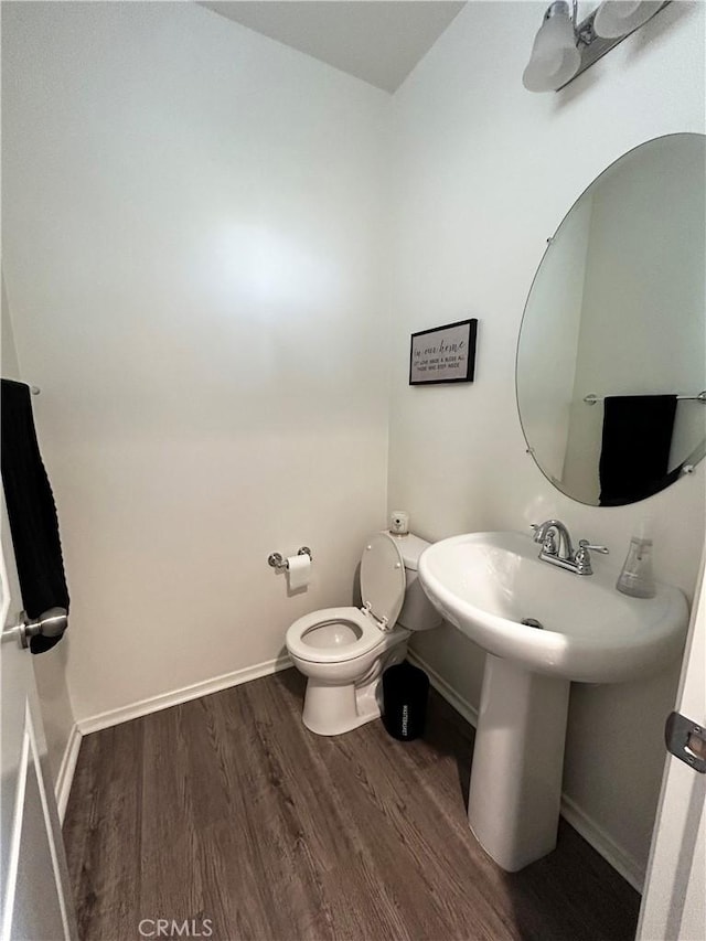 bathroom featuring hardwood / wood-style floors and toilet