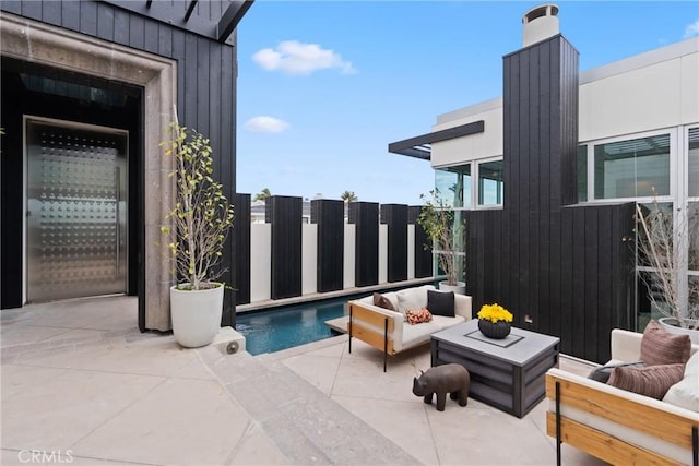 view of patio with an outdoor living space and a fenced in pool