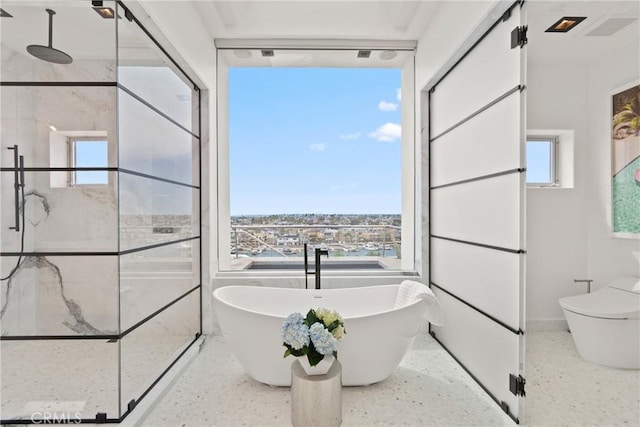 bathroom featuring separate shower and tub and toilet