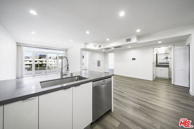 kitchen featuring white cabinetry, stainless steel dishwasher, dark wood-type flooring, and sink