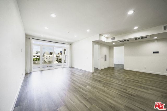 empty room with dark hardwood / wood-style flooring