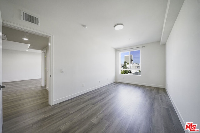 empty room featuring dark wood-type flooring