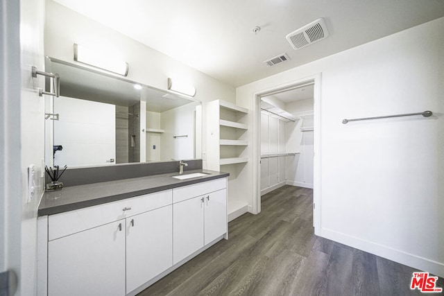 bathroom with vanity and hardwood / wood-style flooring