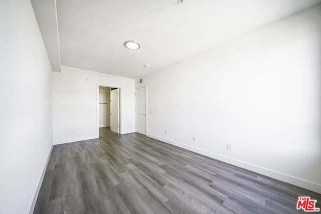 unfurnished bedroom featuring dark hardwood / wood-style flooring