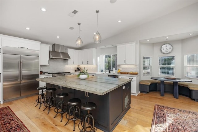 2308 S Ola Vis, San Clemente, CA 92672 - kitchen with a spacious island, wall chimney range hood, white cabinetry, built in fridge, and tasteful backsplash