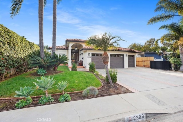 mediterranean / spanish-style house with a garage and a front yard