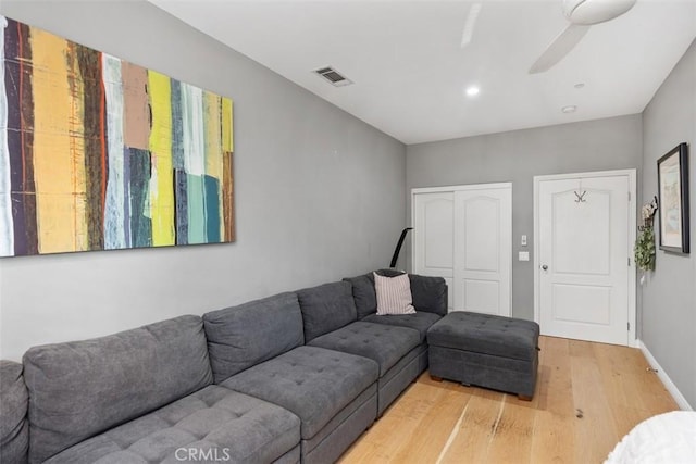 living room featuring hardwood / wood-style flooring and ceiling fan