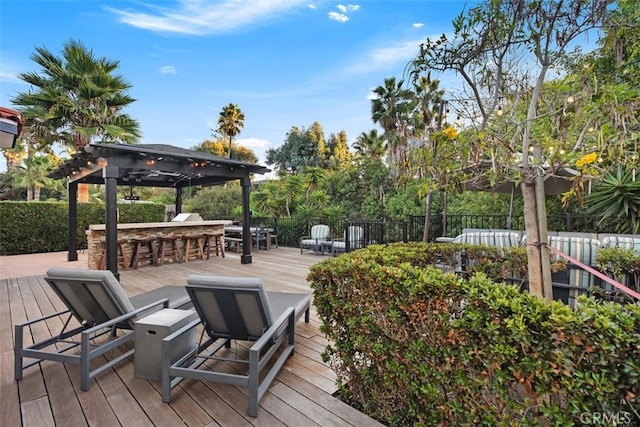 wooden deck featuring exterior bar